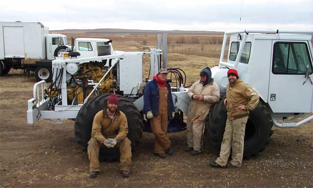 four crew members in front of seismograph